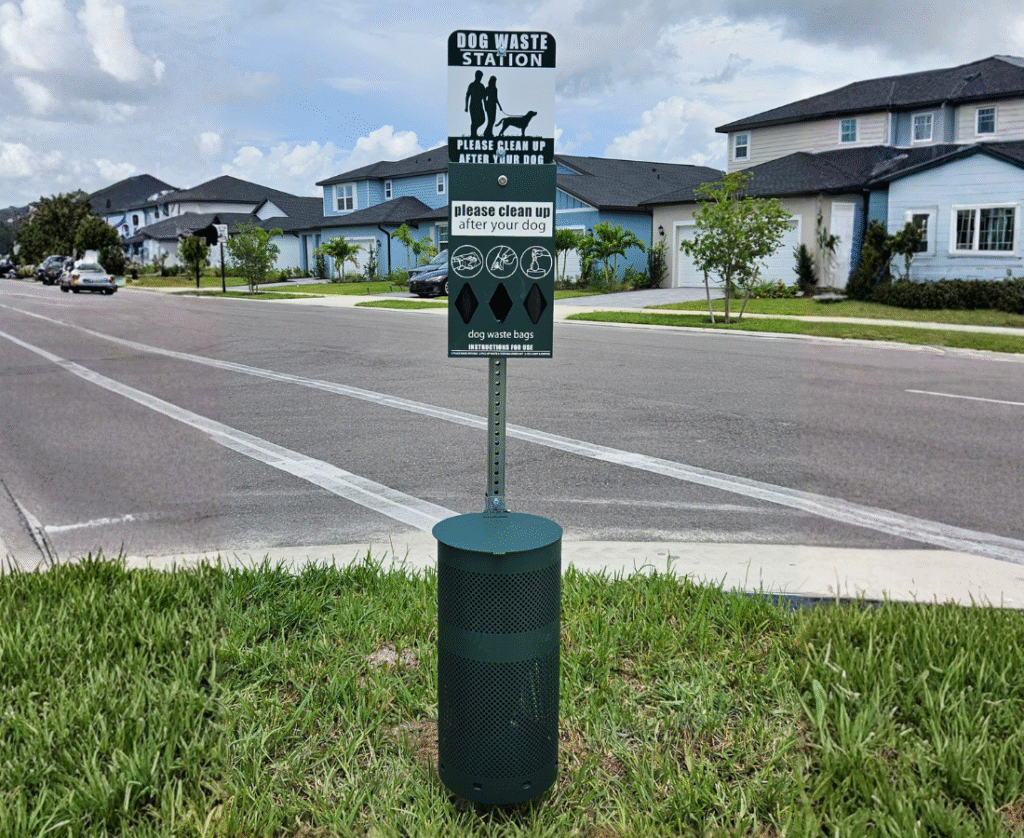Dog waste station with bag dispenser along a residential neighborhood street